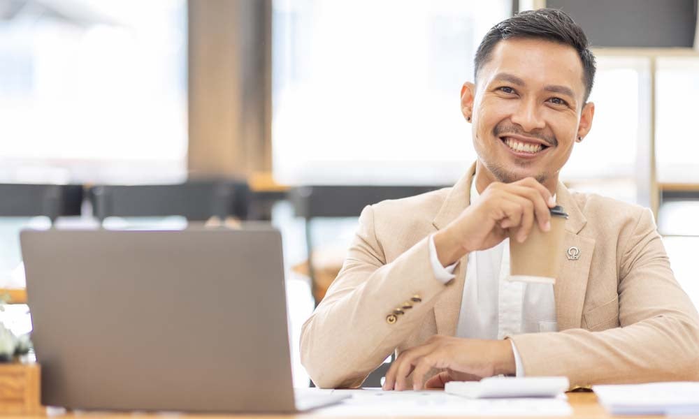 A professional graduate with glass looking at the camera