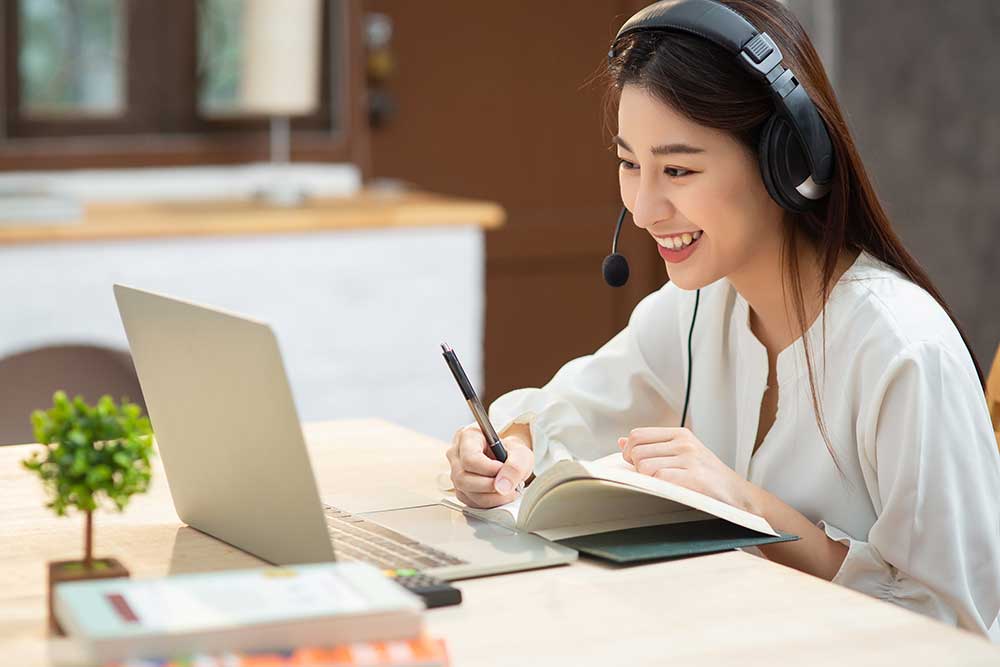 Young female studying on desktop computer 