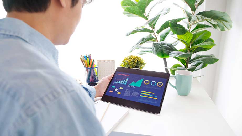 Middle age male using tablet checking statistics