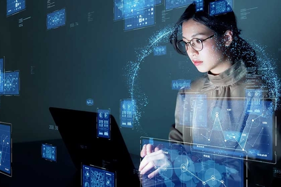 Young female student examining data on a laptop